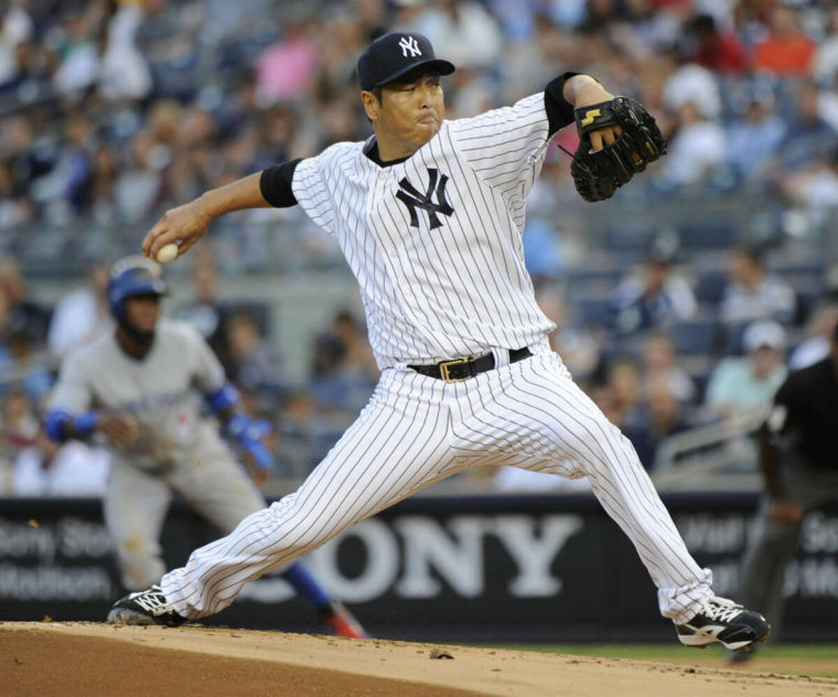 New York Yankees pitcher Hiroki Kuroda delivers the ball to the Toronto Blue Jays during the first inning of a baseball game Friday, July 25, 2014, at Yankee Stadium in New York. (AP Photo/Bill Kostroun)