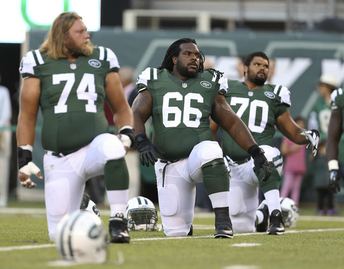FILE - In this Friday, Aug. 21, 2015, file photo, New York Jets guard Willie Colon (66) stretches with teammates Nick Mangold (74), Dakota Dozier (70) and Jarvis Harrison (64) before an NFL preseason football game against the Atlanta Falcons in New York. Colon has dealt with knee issues during the last few years, and has a penchant for penalties. General manager Mike Maccagnan and coach Todd Bowles surprisingly brought Colon back on a one-year deal at the veteran's minimum of $870,000. Heading into the Jets' third preseason game, it appears Colon has all but wrapped up the starting job at right guard, beating out several others who were competing for the spot. (AP Photo/Adam Hunger, File)