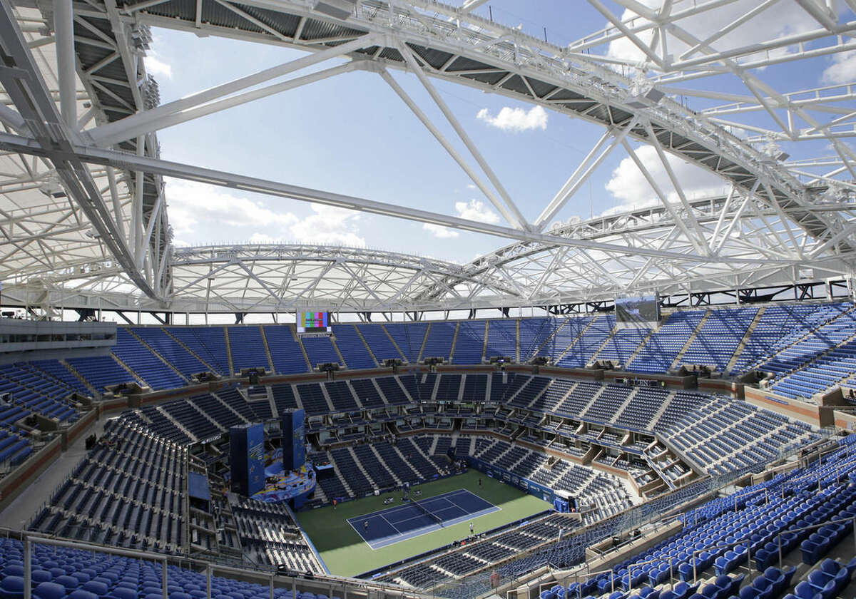 A view from the upper seating section in Arthur Ashe Stadium shows the framework of a retractable roof over the main court at the USTA Billie Jean King National Tennis Center in New York, Thursday, Aug. 27, 2015, home to the U.S. Open tennis tournament. Although rain delays could still plague this year's U.S. Open, fans will be able to watch matches from beneath the shade the roof provides. (AP Photo/Kathy Willens)