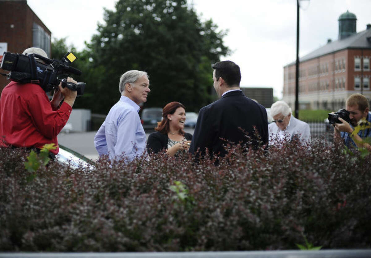Tom Foley, the endorsed Republican candidate for Connecticut governor, second from left, campaigns in New Britain, Conn, Monday, July 28, 2014. Foley, who was trounced by urban voters in his narrow loss four years ago to Dannel Malloy, says this time he is focusing more on cities. (AP Photo/Jessica Hill)