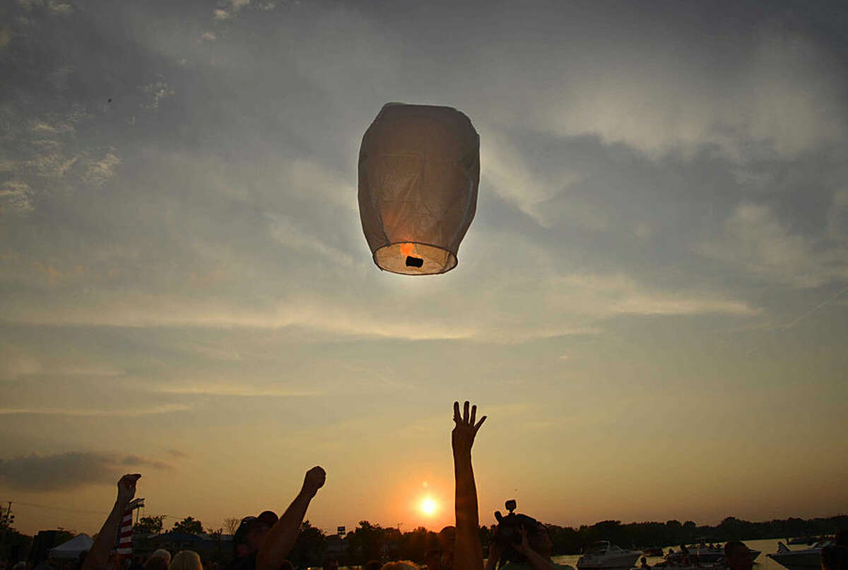 A sky lantern is released during a vigil at Lakefront Park to honor Lt. Charles Joseph Gliniewicz, Wednesday, Sept. 2, 2015, in Fox Lake, Ill. Gliniewicz was shot and killed Tuesday while pursuing a group of suspicious men. Authorities broadened the hunt Wednesday for the suspects wanted in the fatal shooting. (John Starks/Daily Herald via AP) MANDATORY CREDIT; MAGS OUT