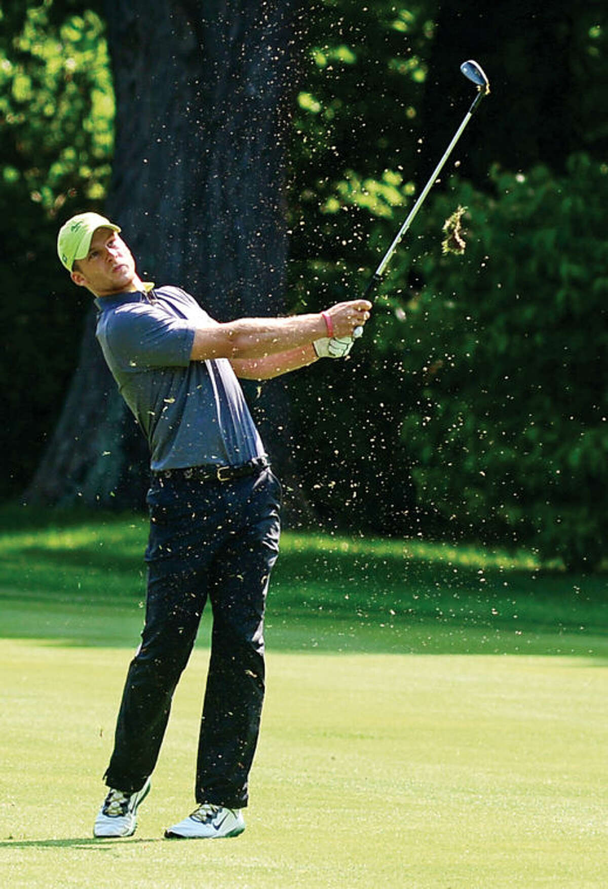 Hour photo / Erik Trautmann John Jackopsic of Gillette Ridge chips onto the first green during the final round of The Connecticut Open Golf championships at Rolling Hills Country Club Wednesday in Wilton.