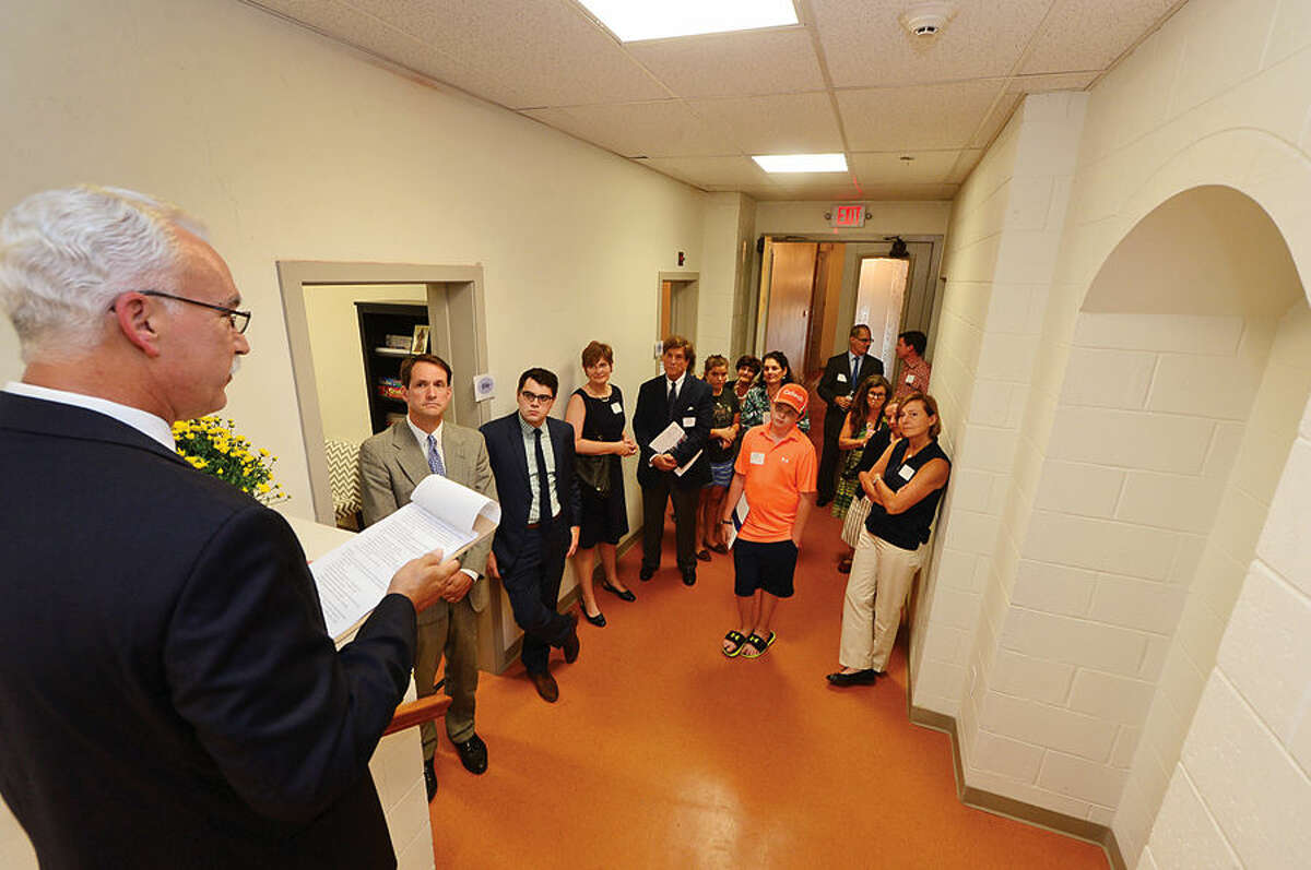 Hour photo / Erik Trautmann John Coperine, Assistant Head of School, left, leads a tour for guests during The Beacon School press conference and dedication ceremony celebrating their move to the historic Hubbard Mansion in Stamford Thursday.