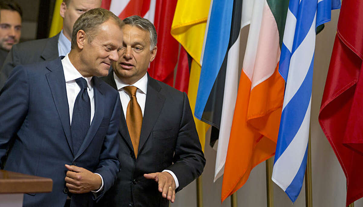 European Council President Donald Tusk speaks with Hungarian Prime Minister Viktor Orban, right, prior to a meeting at the EU Council building in Brussels on Thursday, Sept. 3, 2015. Hungarian Prime Minister Viktor Orban is visiting EU officials on Thursday to discuss the current migration crisis. (AP Photo/Virginia Mayo)