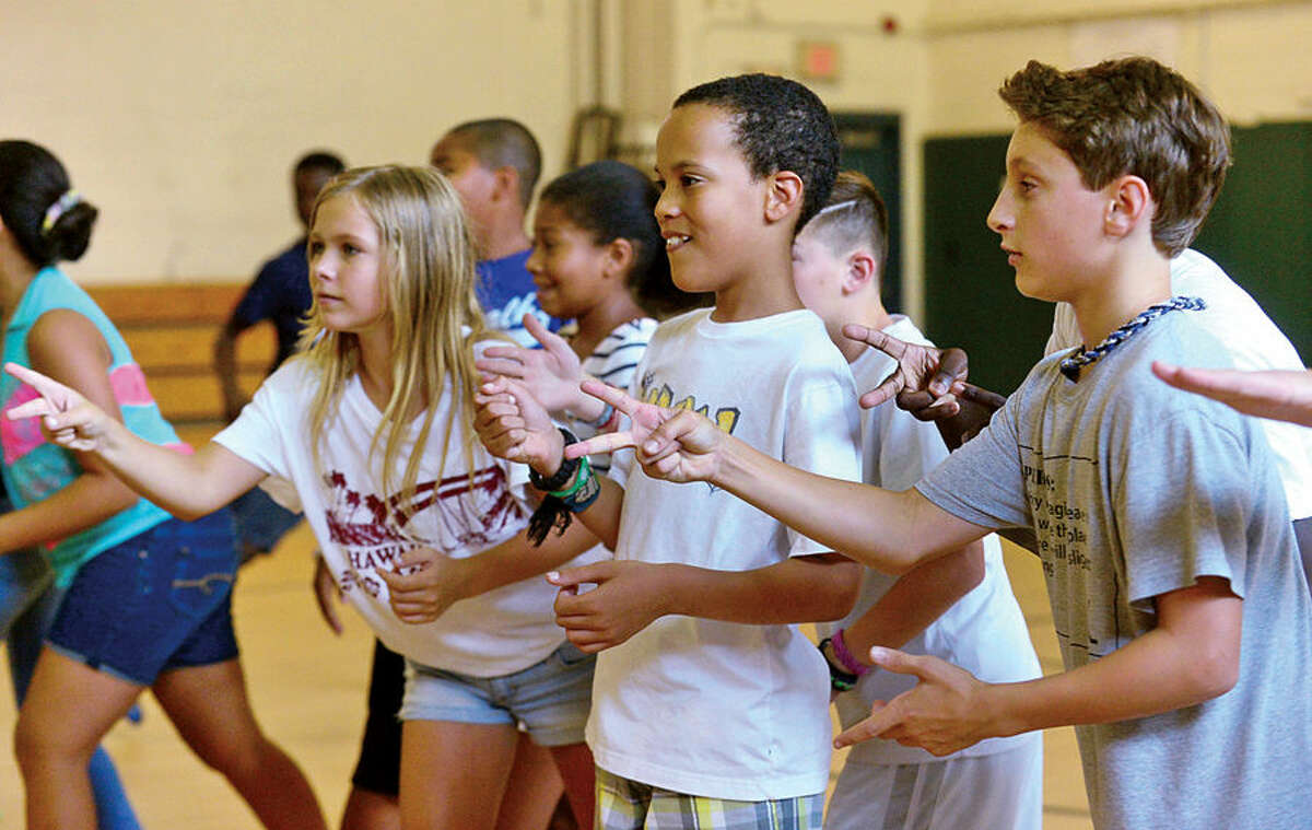 Hour photo / Erik Trautmann Ponus Ridge Middle School 7th graders including Eva Tracy, Devon Morales and Gary Claps, take part in the Positive Behavioral Intervention & Supports (PBIS) team activity, Rock, Paper, Scissors, during a school-wide PBIS Day Friday.