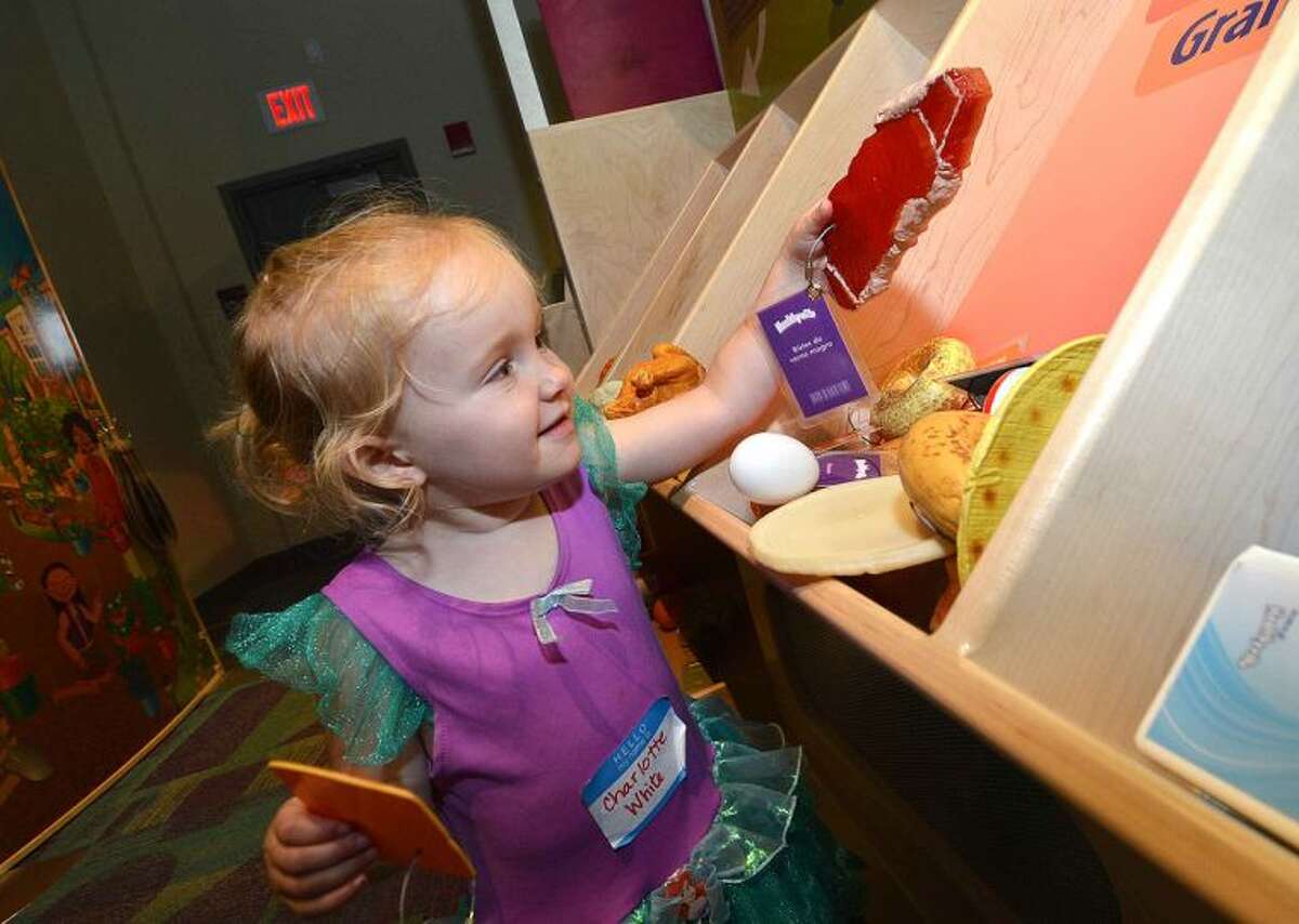 Hour Photo/Alex von Kleydorff Charlotte White looks at the different types of food while she 'Builds a Healthy Plate' at Norwalk Hospital's NICU Reunion party at Stepping Stones Museum for Children