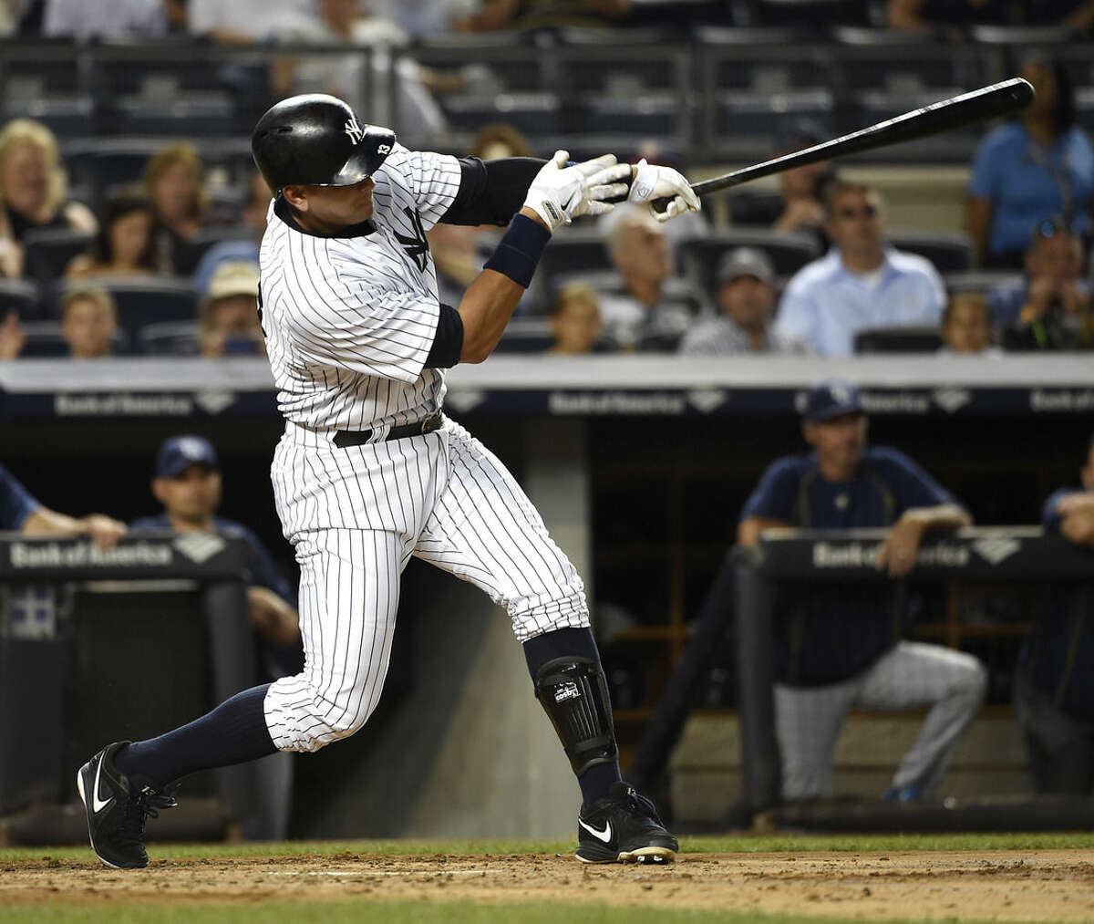 New York Yankees designated hitter Alex Rodriguez hits a two-run home run off of Tampa Bay Rays starting pitcher Jake Odorizzi in the second inning of a baseball game at Yankee Stadium on Friday, Sept. 4, 2015, in New York. (AP Photo/Kathy Kmonicek)