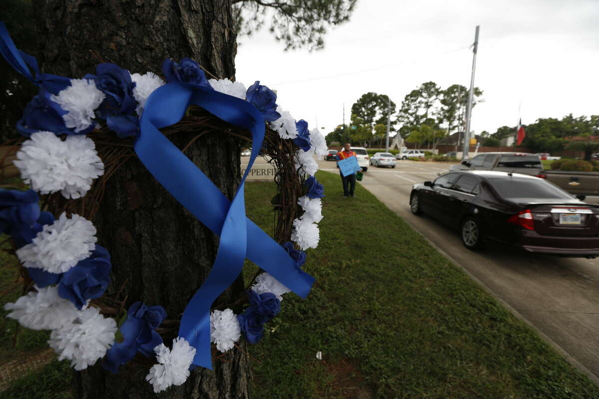 A car passes by a wreath that rests across the street from a gas station where Deputy Darren Goforth was fatally shot Tuesday, Sept. 1, 2015, in Houston. Godforth was shot while at a gas station. The man accused of fatally shooting the suburban Houston officer was committed to mental health facilities in the last five years and his attorney said Tuesday the man will undergo a psychological evaluation. (Steve Gonzales/Houston Chronicle via AP) MANDATORY CREDIT