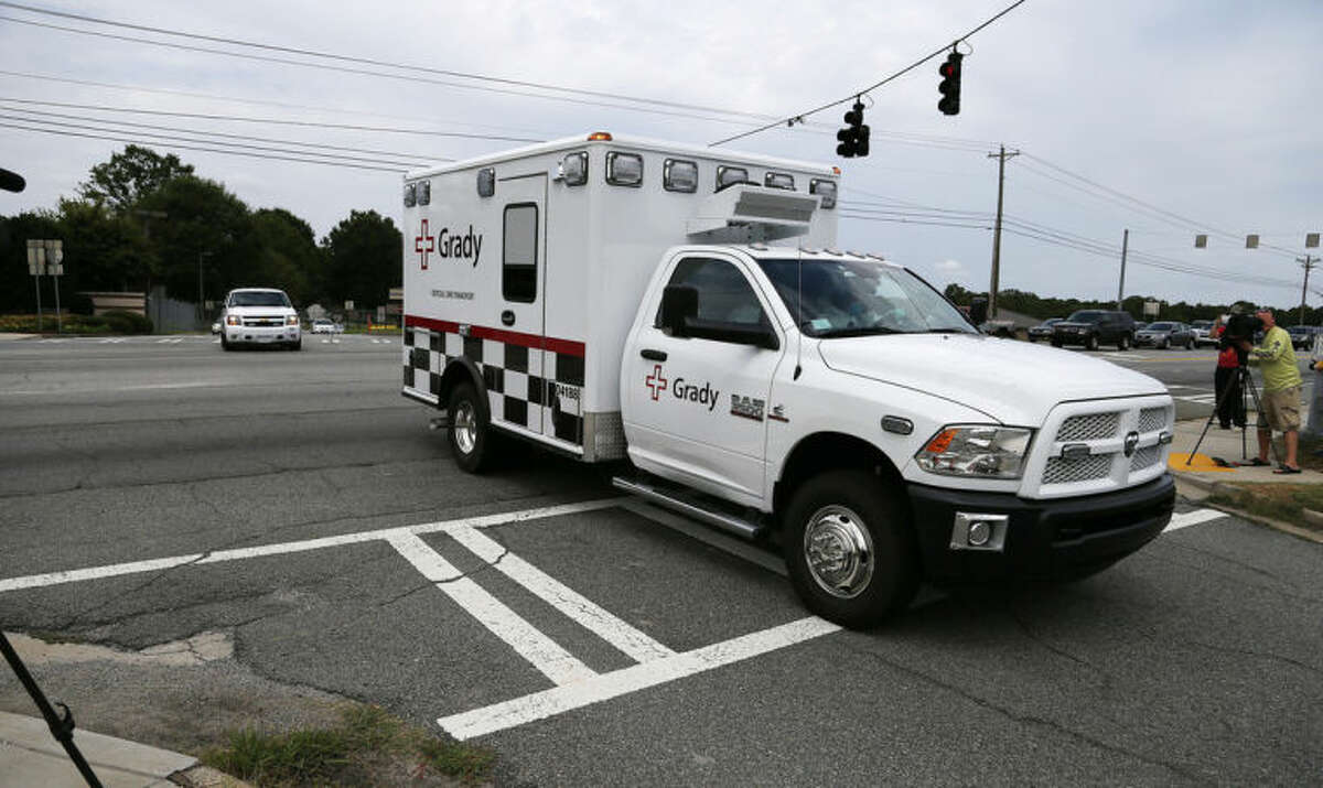 An ambulance departs Dobbins Air Reserve Base, Saturday, Aug. 2, 2014, in Marietta, Ga. Officials at Emory University Hospital in Atlanta expect an American that was infected with the Ebola virus to be transported today. (AP Photo/Mike Stewart)
