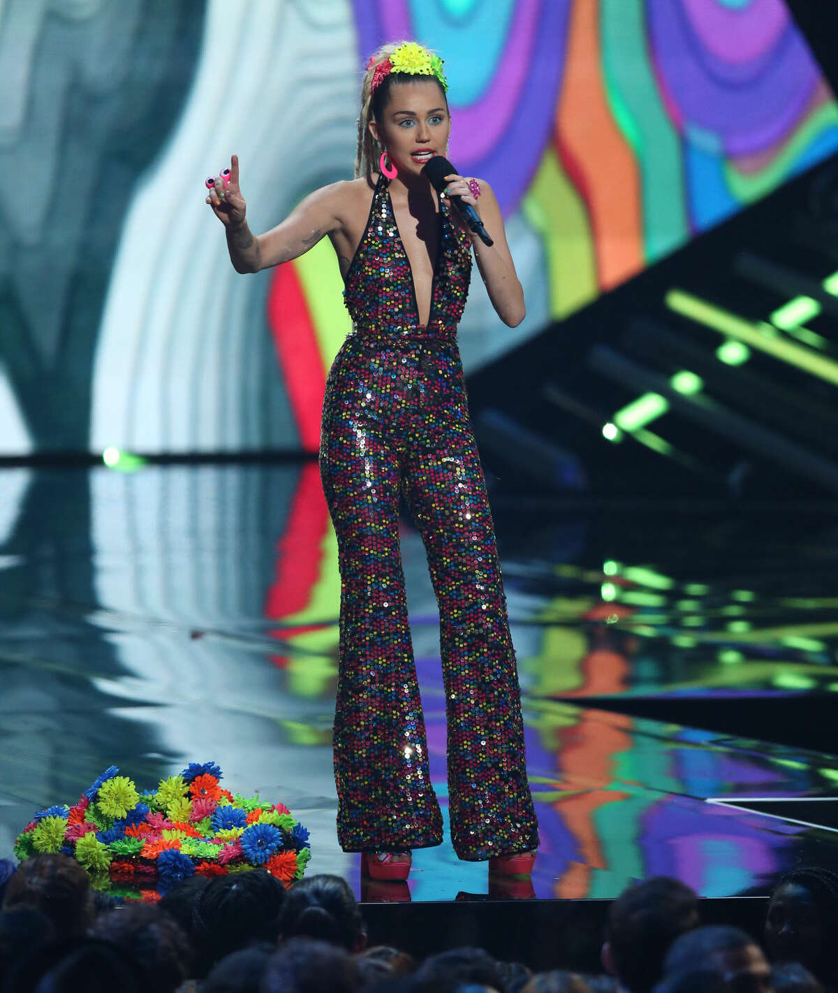 Host Miley Cyrus speaks at the MTV Video Music Awards at the Microsoft Theater on Sunday, Aug. 30, 2015, in Los Angeles. (Photo by Matt Sayles/Invision/AP)