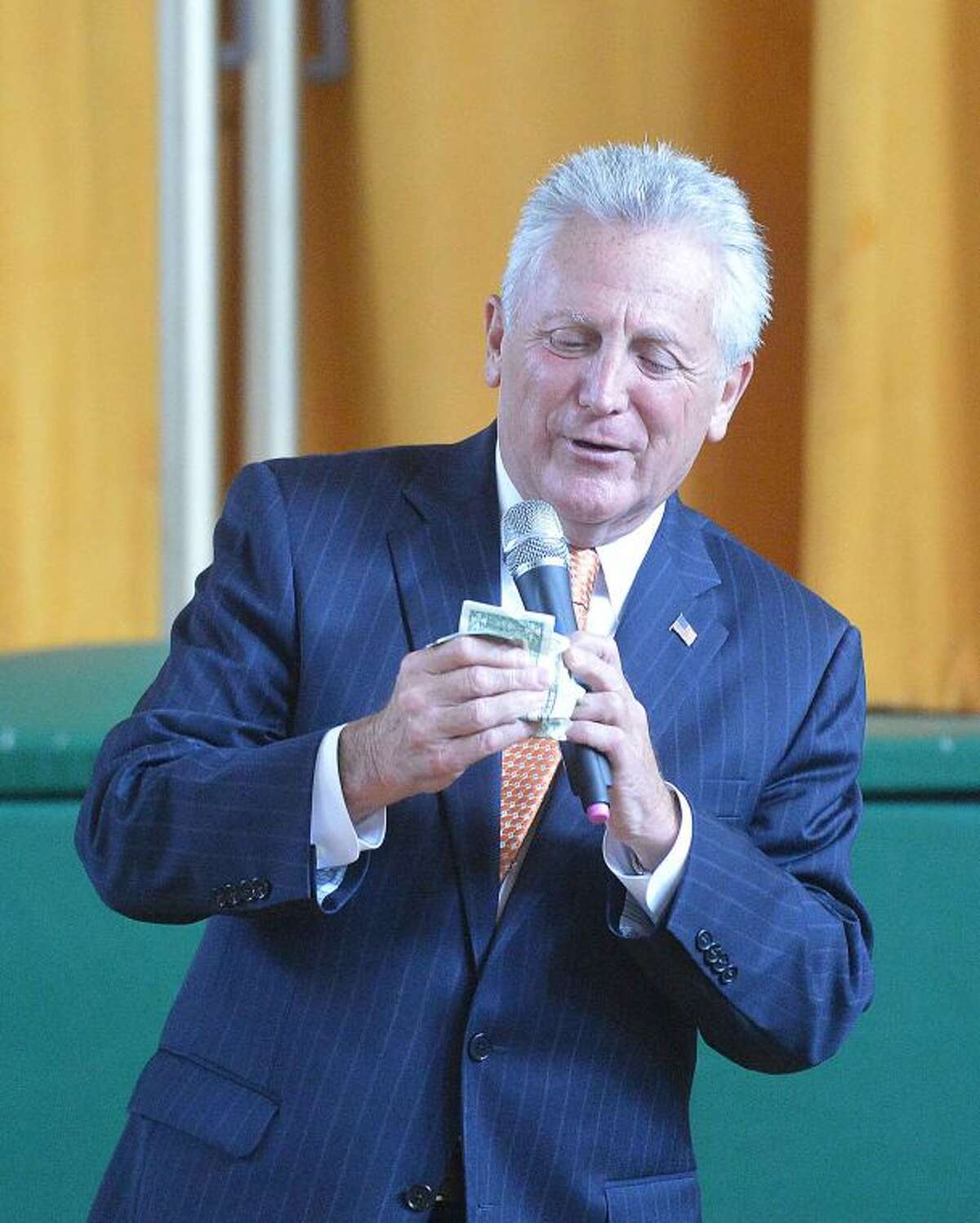 Hour Photo/Alex von Kleydorff Mayor Harry Rilling empties his wallet to make a donation to Coins for Cancer at Fox Run School on Monday