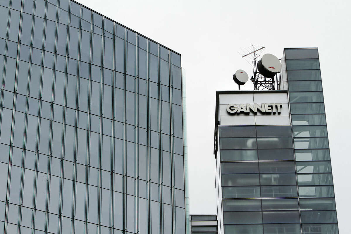 FILE - This July 14, 2010, file photo, shows Gannett headquarters in McLean, Va. Gannett is spinning off its publishing business from its broadcasting and digital operations. The company is also acquiring full ownership of Cars.com for $1.8 billion., the company announced Tuesday, Aug. 5, 2014. (AP Photo/Jacquelyn Martin, File)