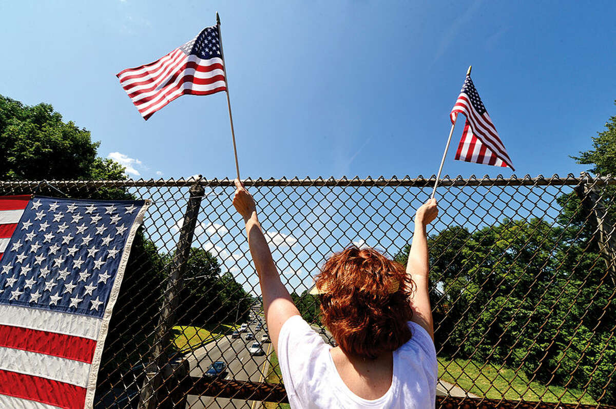 Hour photo / Erik Trautmann Area residents with Overpasses for America protest the immigration policy of the Obama administration on the I-95 overpass on Stawberry Hill Ave in Norwalk Saturday.