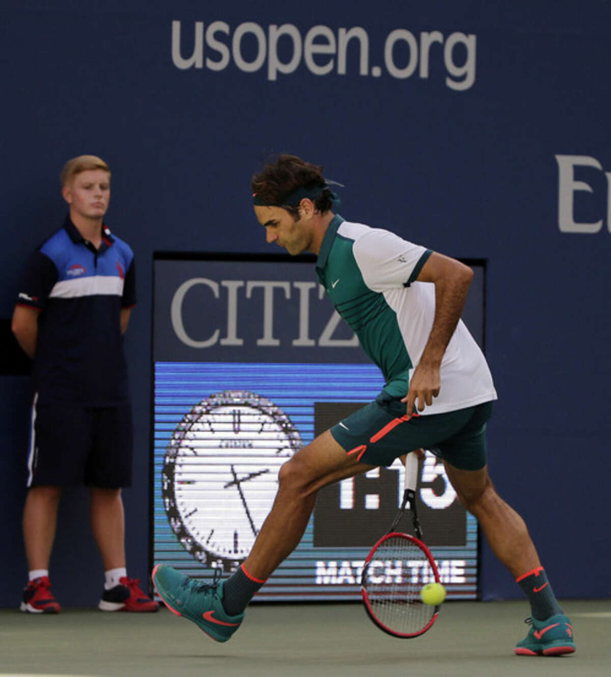Roger Federer, of Switzerland, returns a shot from between his legs to Philipp Kohlschreiber, of Germany, during the third round of the U.S. Open tennis tournament, Saturday, Sept. 5, 2015, in New York. (AP Photo/Charles Krupa)