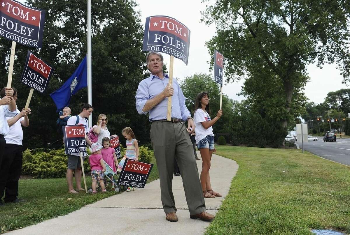 Republican candidate for Connecticut governor Tom Foley, center, greets commuters off an exit during rush hour, Monday, Aug. 11, 2014, in West Hartford, Conn. Foley will face Republican John McKinney in Tuesday's primary. (AP Photo/Jessica Hill)