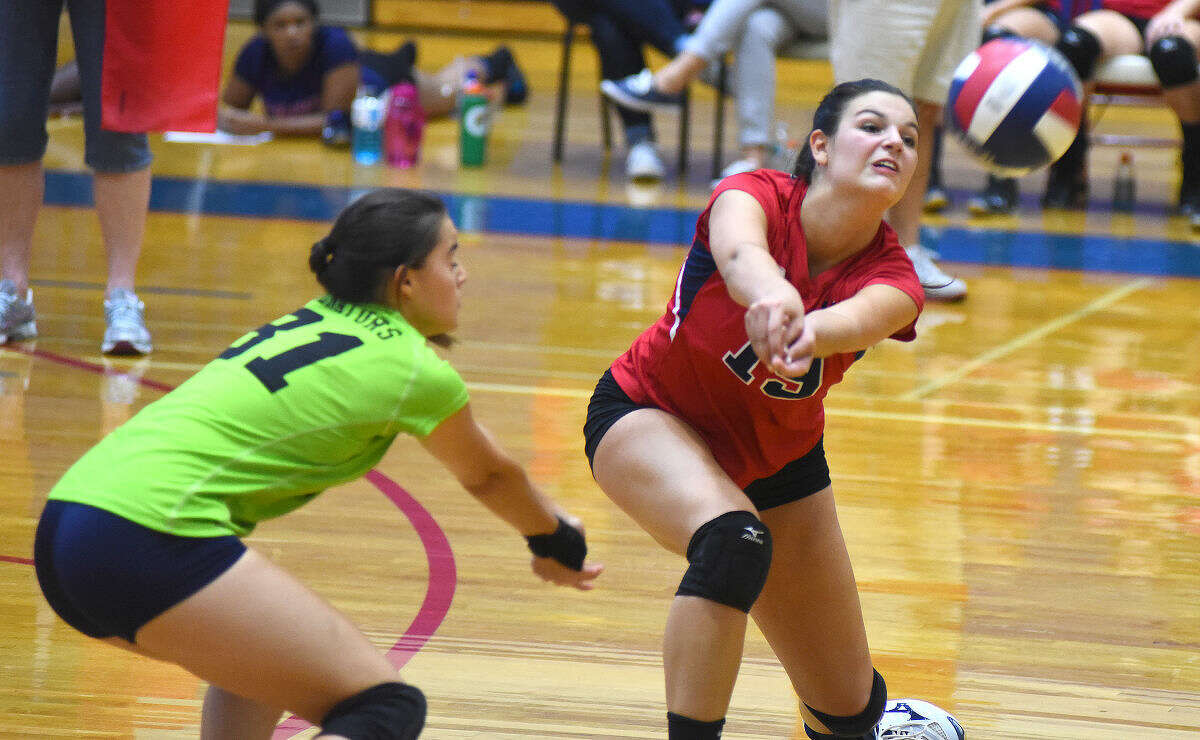 Hour photo/John Nash - Action from Friday's season-opening FCIAC volleyball game between Brien McMahon and New Canaan in Norwalk. The Senators defeated the Rams 3-0.