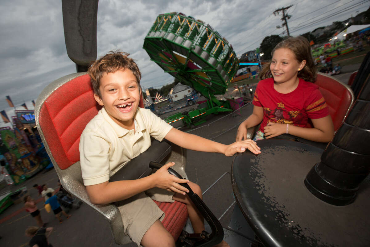 Hour photo/Chris Palermo. Mikkel Pereira, 6, and Fiona Jaimes, 10, ride the tornado ride at the Oyster Festival Saturday afternoon.