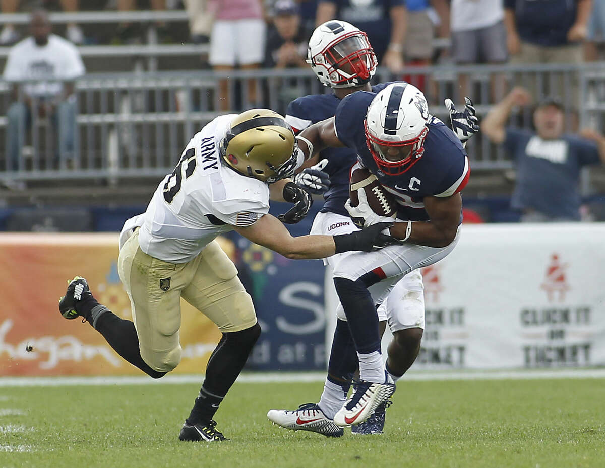 Connecticut safety Andrew Adams, right, intercepts a pass intended for Army running back John Trainor (6) during the fourth quarter of an NCAA college football game at Pratt & Whitney Stadium at Rentschler Field, Saturday, Sept. 12, 2015, in East Hartford, Conn. Connecticut defeated Army 22-17. (AP Photo/Stew Milne)