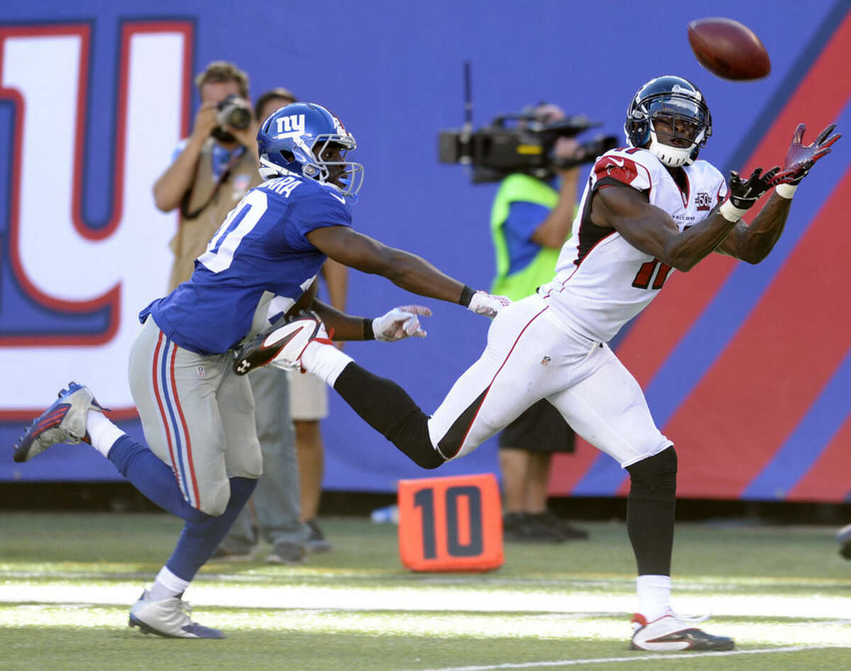 Atlanta Falcons wide receiver Julio Jones, right, makes a catch near the end zone on a pass from quarterback Matt Ryan, not pictured, as New York Giants cornerback Prince Amukamara defends on the play during the second half of an NFL football game, Sunday, Sept. 20, 2015, in East Rutherford, N.J. (AP Photo/Bill Kostroun)