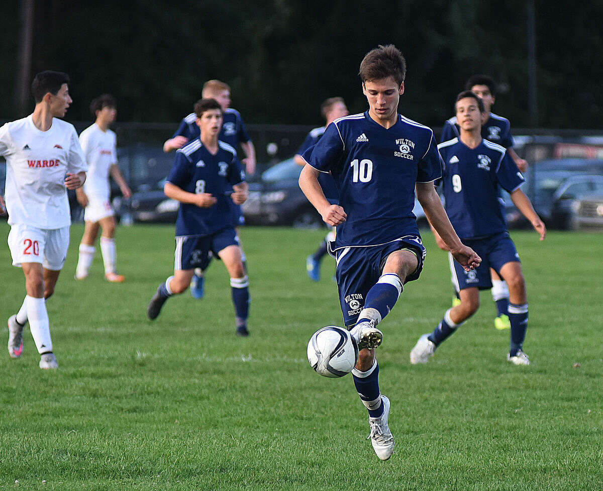 Wilton's Jack Brandt (10) plays the ball up field during Monday's game at Fairfield Warde.