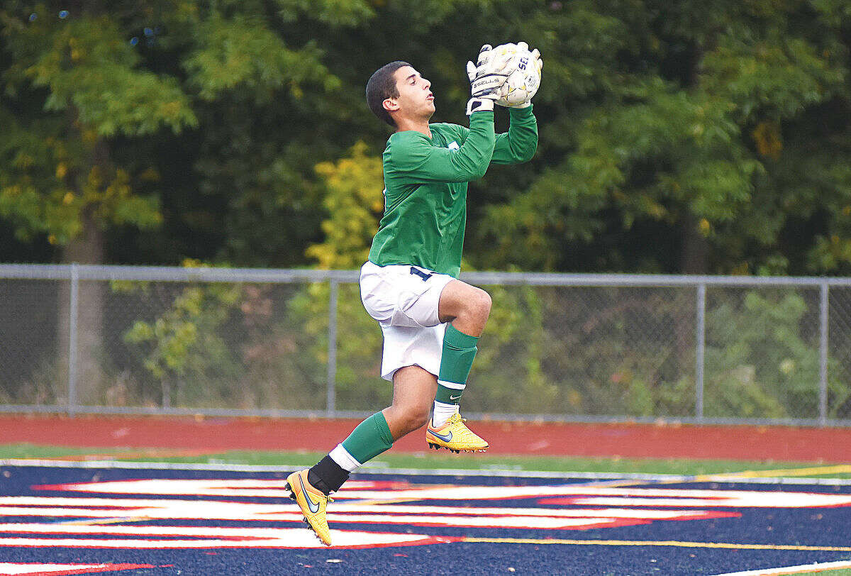 Hour photo/John Nash - Staples goalkeeper Noah Schwaeber makes a leaping save during Wednesday's game against Brien McMahon.