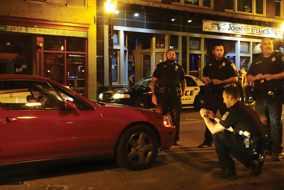 Hour photo/Jeff Dale Norwalk police investigate a hit and run with a pedestrian Thursday night on Washington Street.