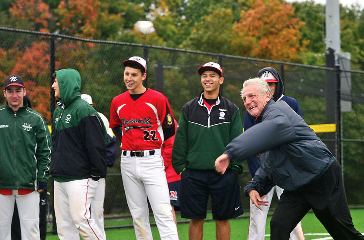 Hour photo / Erik Trautmann Norwalk mayor Harry Rilling throws out the ceremonial first pitch during the grand opening of new Athletic Complex at Nathan Hale Middle School Saturday.