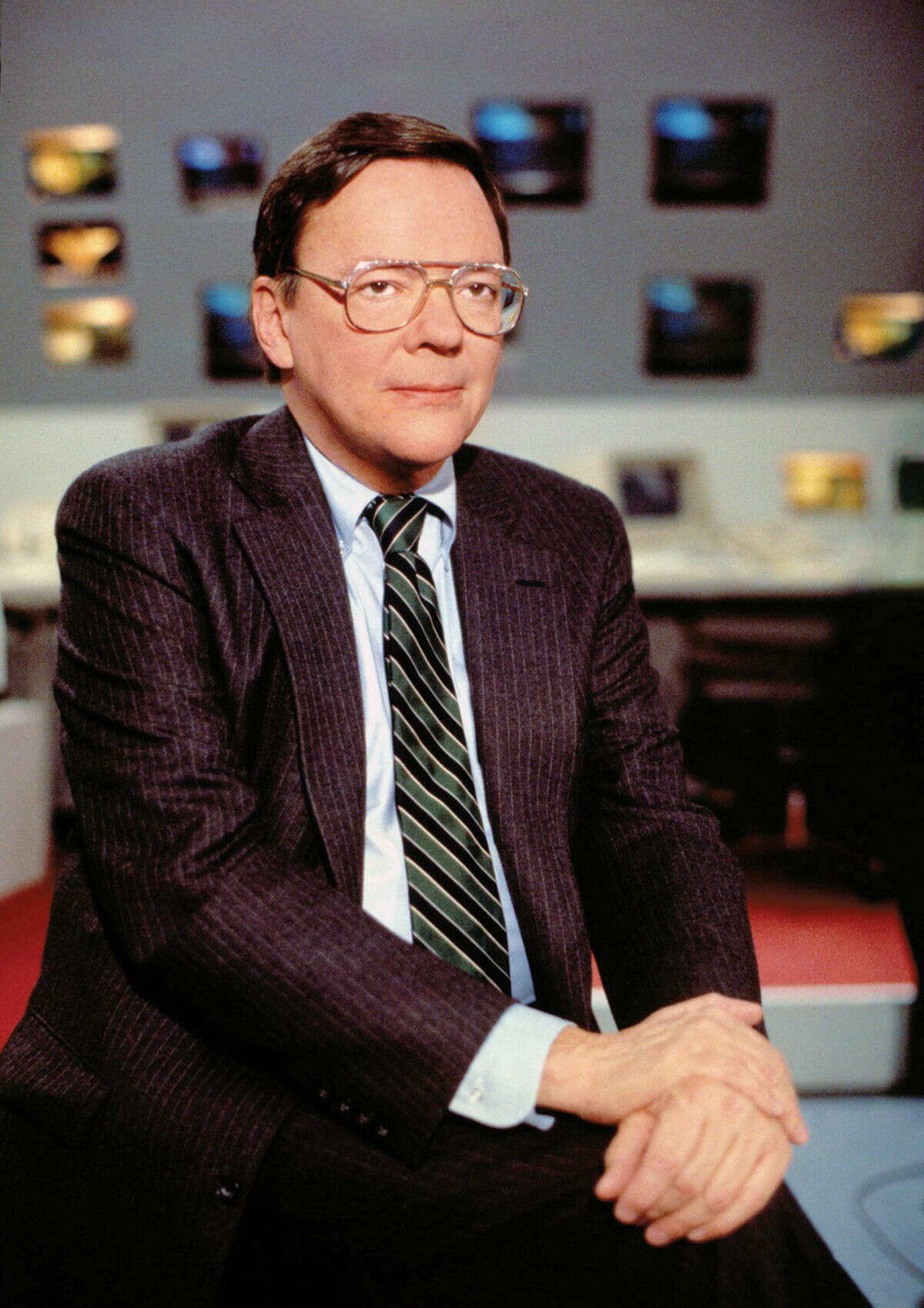 In this June 28, 1988 photo released by CBS, CBS News correspondent Bruce Morton poses on the set of the CBS news room in New York. Morton, an award-winning political correspondent for CBS News who also covered the Vietnam War and the space program, died Friday, Sept. 5, 2014, at his home in Washington, D.C., after a battle with cancer. He was 83. (AP Photo/CBS)