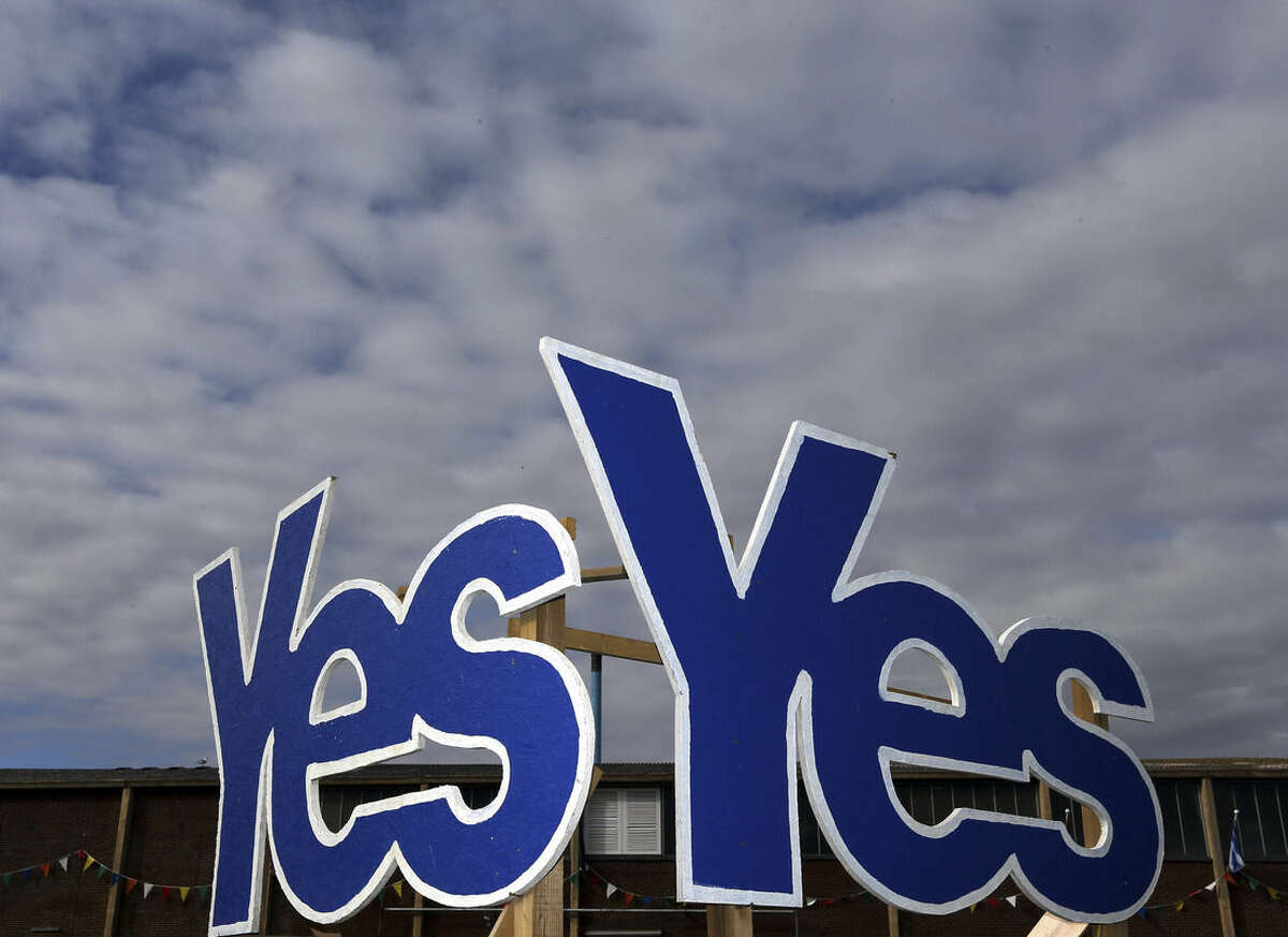 Yes Signs are displayed in Eyemouth, Scotland, Monday, Sept. 8, 2014. Polls predict a very close vote in the upcoming landmark referendum on Scottish independence from Britian on September 18. (AP Photo/Scott Heppell)