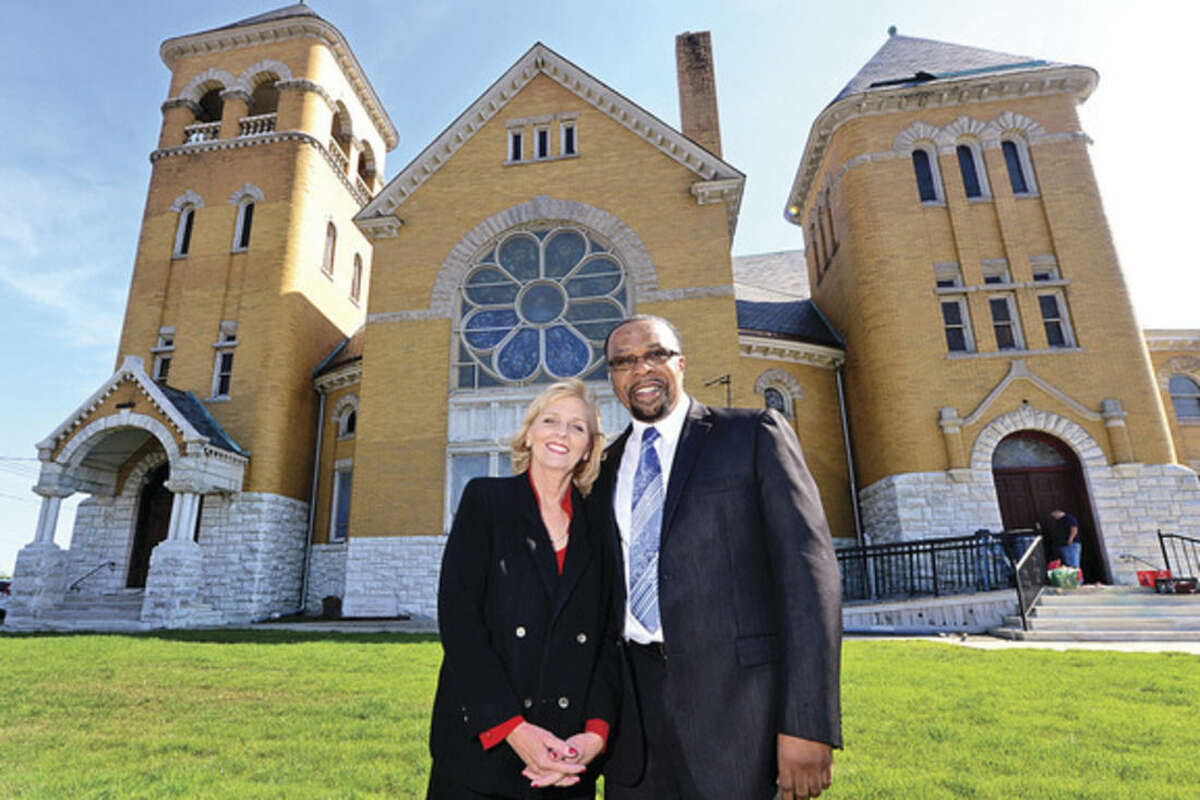 Hour photo / Erik Trautmann Board member Joleen Green and Pastor Reverend Dewitt Stevens stand in front of the Macedonia Church's new renovated building on West Ave. The church plans their grand opening Sunday October 17th.