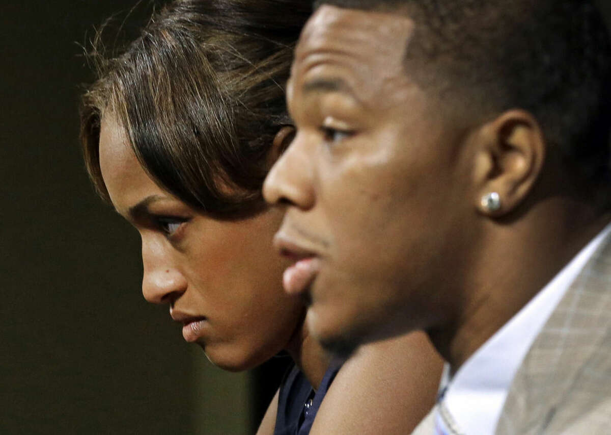 FILE - In this May 23, 2014, file photo, Janay Rice, left, looks on as her husband, Baltimore Ravens running back Ray Rice, speaks to the media during a news conference in Owings Mills, Md. A new video that appears to show Ray Rice striking then-fiance Janay Palmer in an elevator last February has been released on a website. (AP Photo/Patrick Semansky, File)