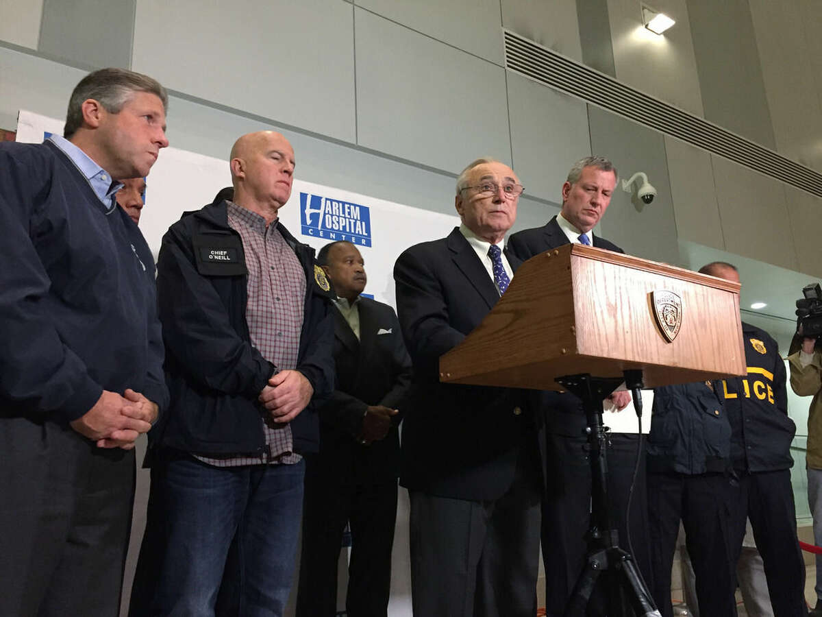 New York Police Commissioner William Bratton speaks while Mayor Bill de Blasio, right, Patrolmen's Benevolent Association President Patrick Lynch, left, and NYPD Chief of Department James O'Neill listen early Wednesday, Oct. 21, 2015, in New York. A New York City police officer died after being shot in the head in a gun battle while pursuing a suspect following a report of shots fired Tuesday, police said. "He is the fourth New York City police officer murdered in this city in the last 11 months," Bratton said during a news conference at Harlem Hospital where Officer Randolph Holder, 33, was pronounced dead Tuesday night. (AP Photo/Michael Balsamo)