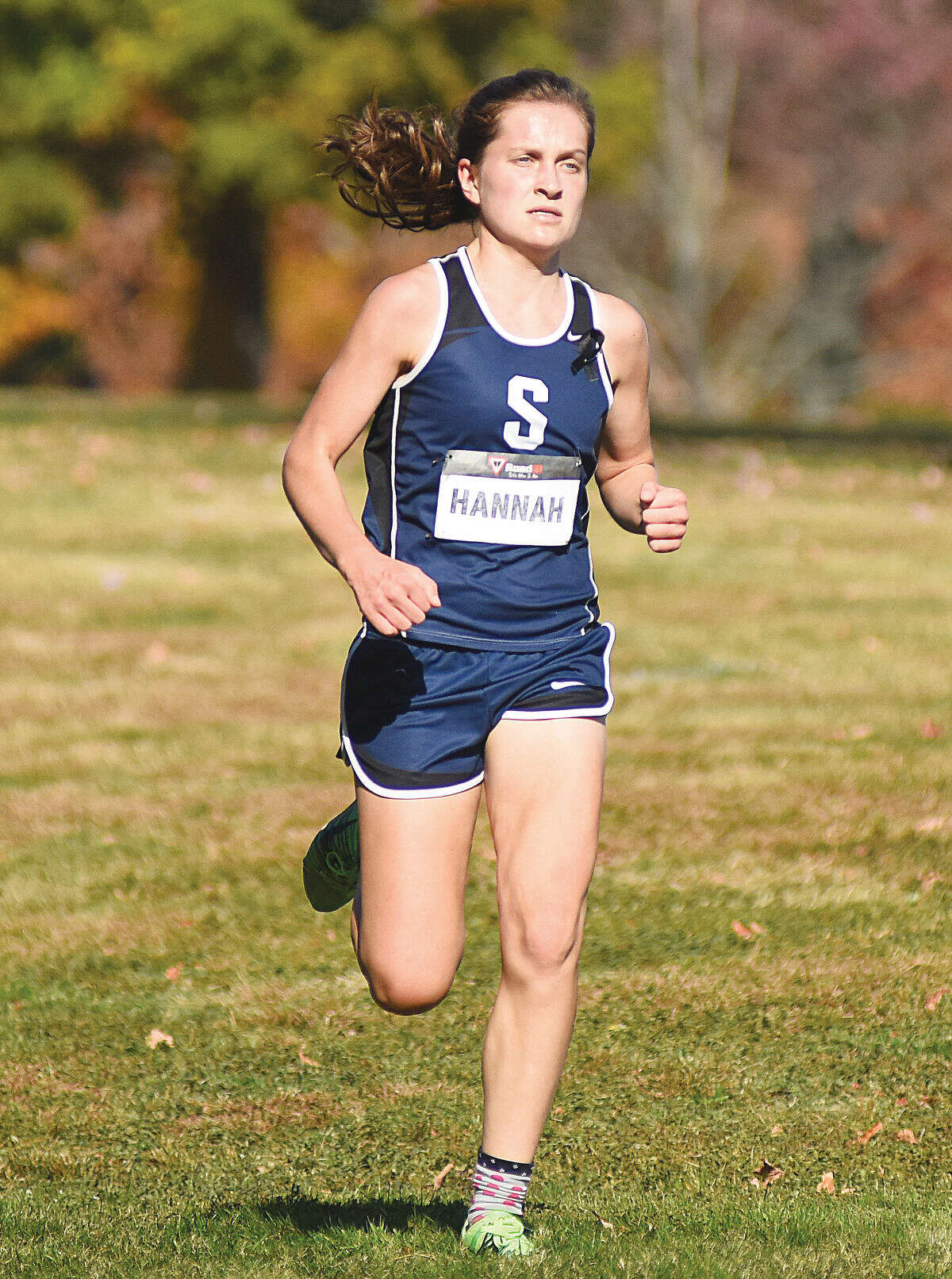 Hour photo/John Nash - Staples' Hannah DeBalsi runs along the course at Waveny Park in New Canaan on Wednesday, en route to her third straight FCIAC championship.