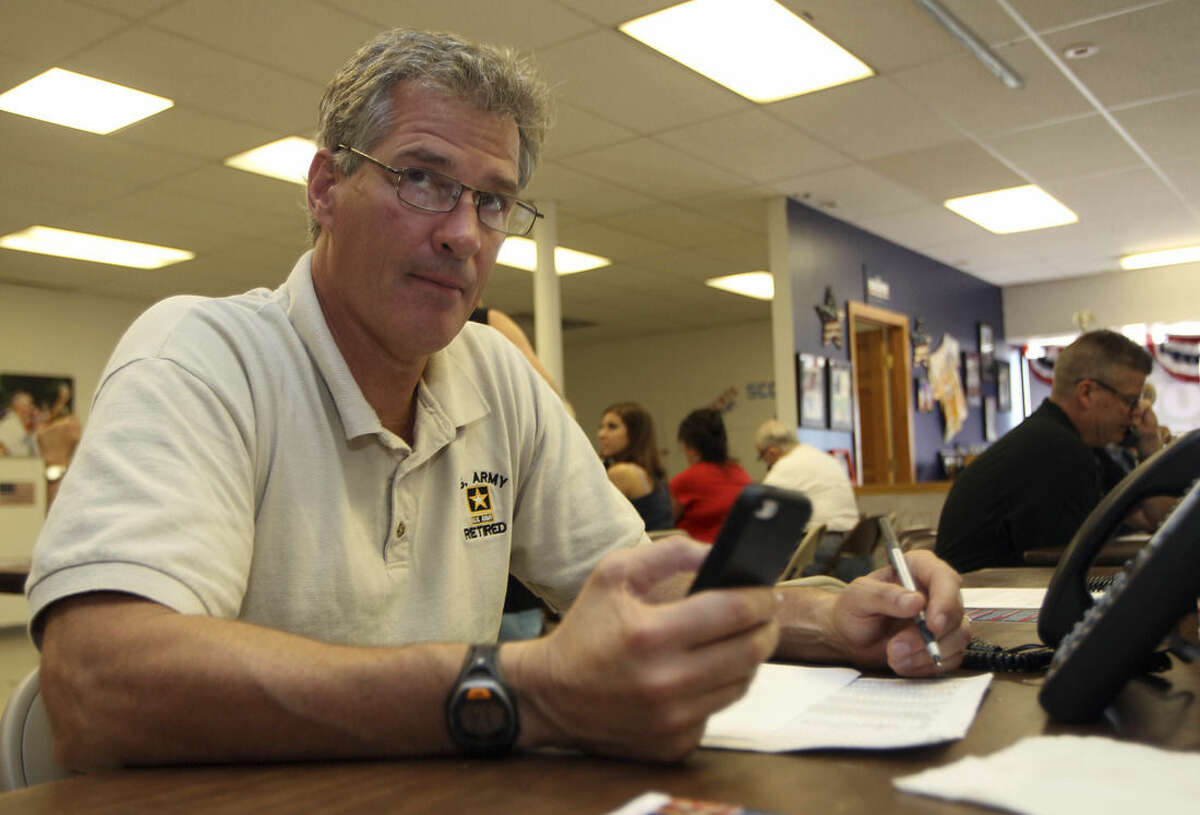 Scott Brown, a former U.S. Senator from Massachusetts, makes phone calls to voters from his headquarters Tuesday Sept. 9, 2014 in Manchester, N.H. Brown moved to New Hampshire and is seeking the Republican party nomination for U.S. Senate hoping to unseat Democrat Jeanne Shaheen. (AP Photo/Jim Cole)