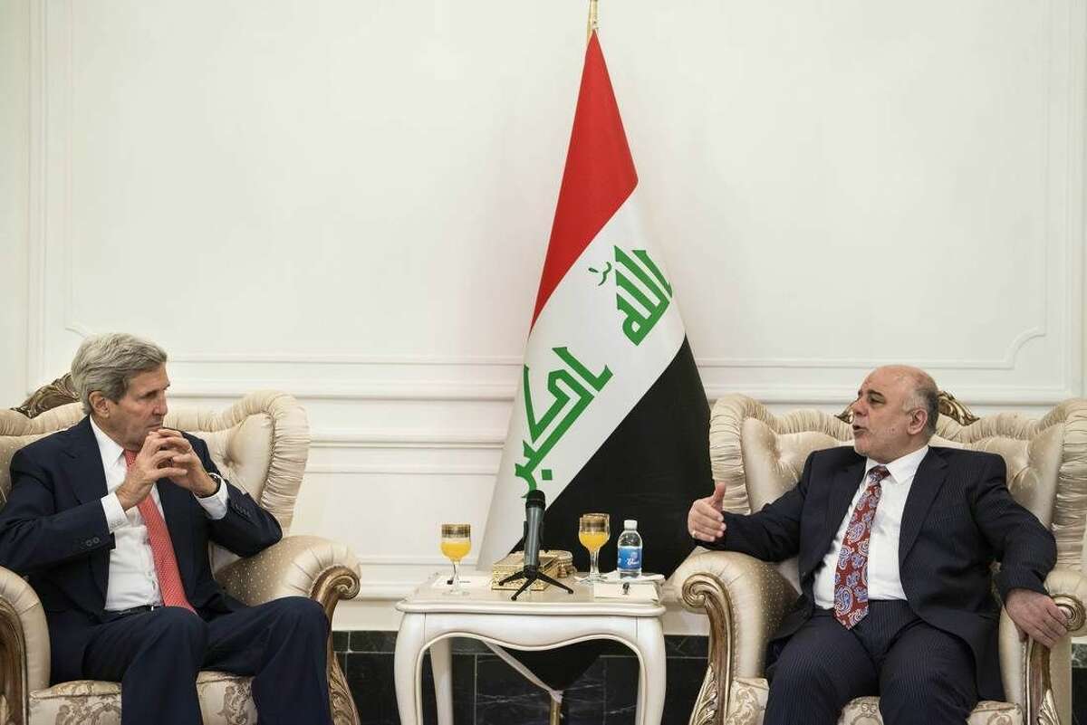 U.S. Secretary of State John Kerry, left, listens to new Iraqi Prime Minister Haider al-Abadi during a meeting in Baghdad, Iraq, Wednesday, Sept. 10, 2014. Kerry is traveling to the mideast this week to discuss ways to bolster the stability of the new Iraqi government and combat the Islamic State militant group that has taken over large swaths of Iraq and Syria. (AP Photo/Brendan Smialowski, Pool)