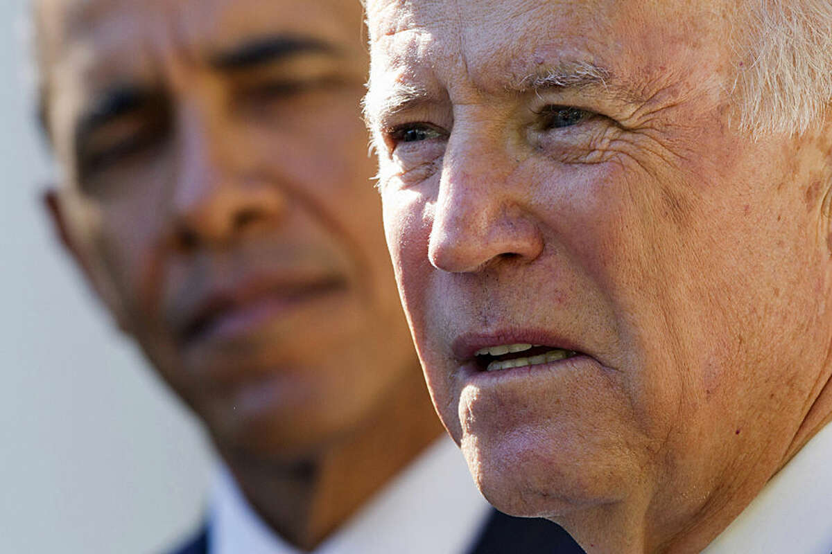 President Barack Obama listens as Vice President Joe Biden speaks in the Rose Garden of the White House in Washington, Wednesday, Oct. 21, 2015, to announce that he will not run for the presidential nomination. (AP Photo/Jacquelyn Martin)