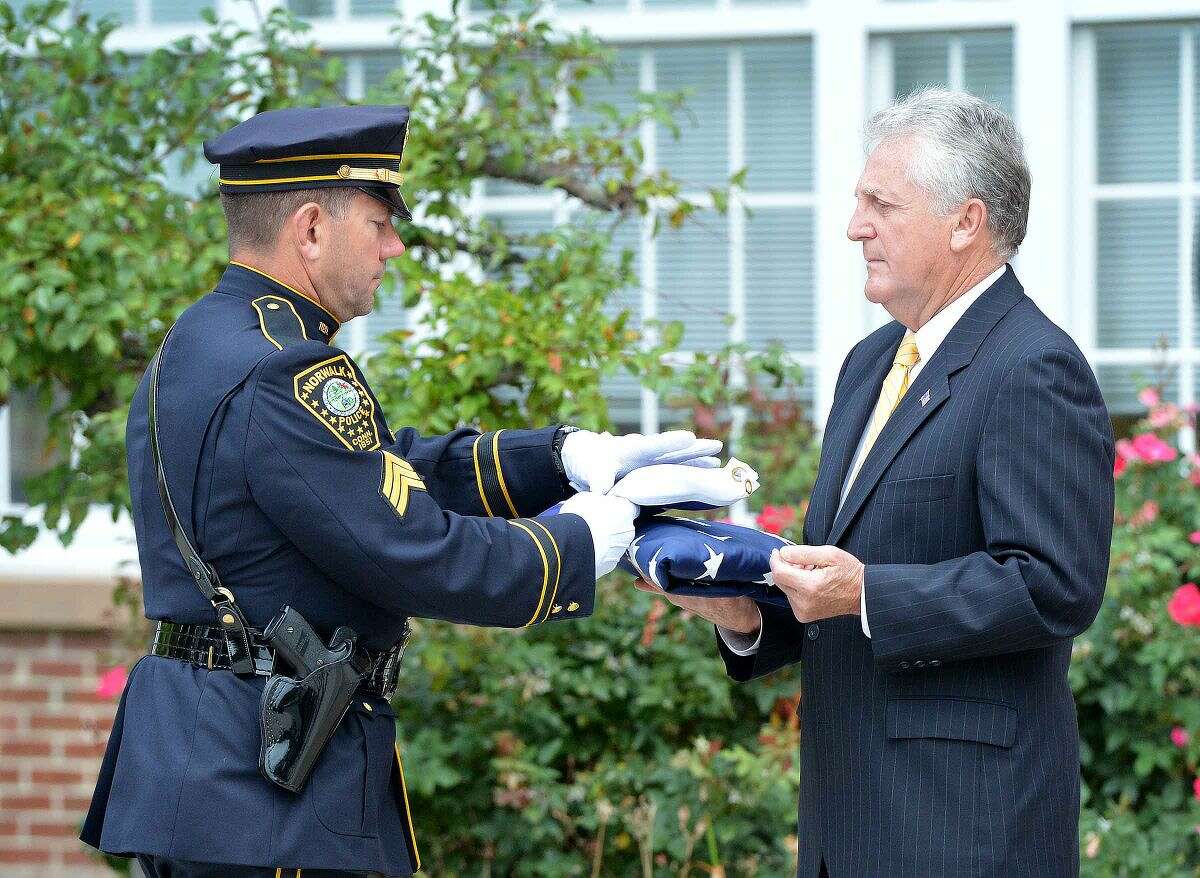 Hour Photo/Alex von Kleydorff Mayor Harry Rilling accepts the Flag of Honor during Norwalk Remembers , 9-11 Rememberance Ceremony at City Hall
