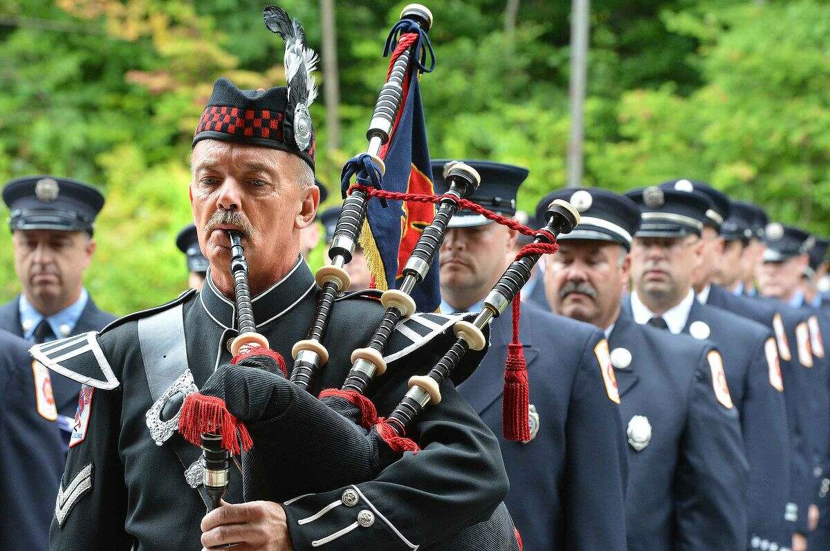 Hour Photo/Alex von Kleydorff Wilton Fire Department's Ralph Nathanson plays the bagpipes during a procession at Wilton's 13th Annual 9-11 Memorial Service at Wilton fire Headquarters