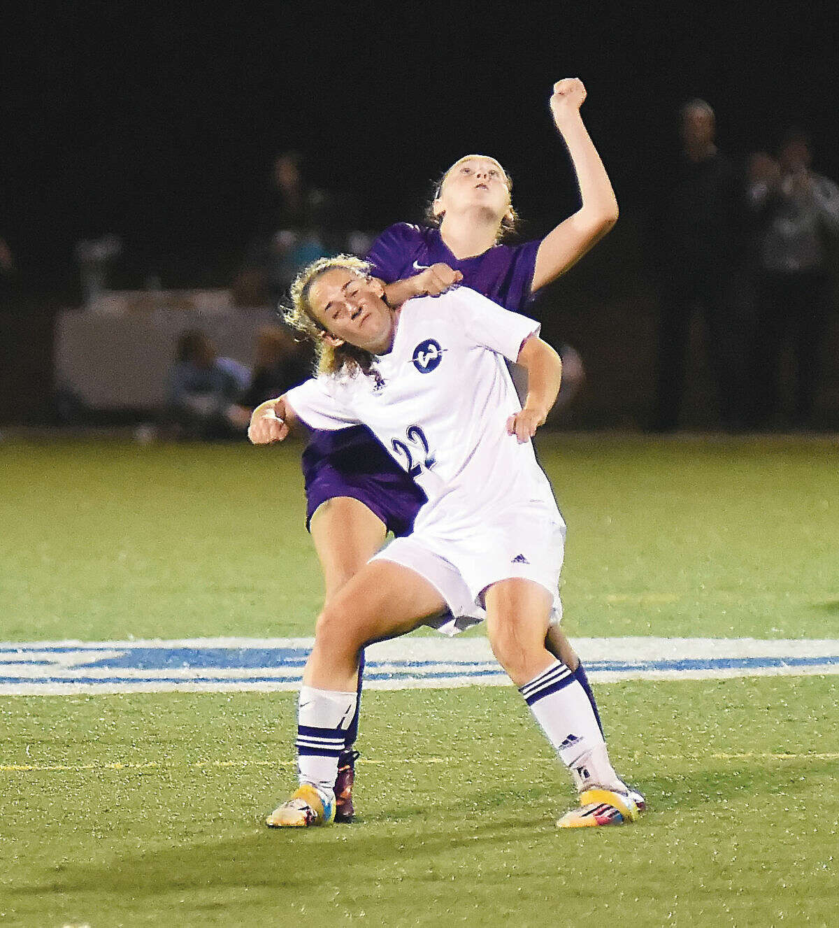 Hour photo/John Nash - Wilton's Rebecca Hersch, front, gets physical with a Westhill player as the two wait to play a head ball during Thursday's FCIAC girls soccer game at Kristine Lilly Field in Wilton.