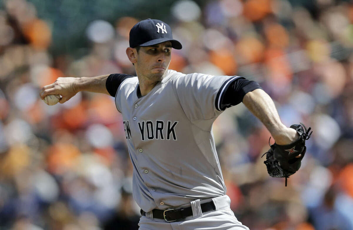 New York Yankees starting pitcher Brandon McCarthy throws to the Baltimore Orioles during the first inning in the first baseball game of a doubleheader, Friday, Sept. 12, 2014, in Baltimore. (AP Photo/Patrick Semansky)