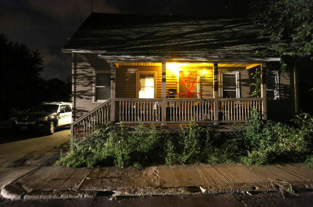 A Blackstone, Mass. police vehicle sits next to a house where a Massachusetts prosecutor said the bodies of three infants were found, Thursday, Sept. 11, 2014, in Blackstone. Worcester County District Attorney Joseph Early Jr. said authorities don't know when or how the babies died. (AP Photo/Steven Senne)