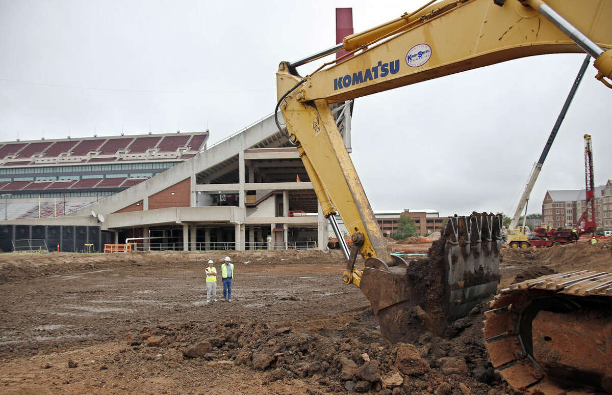 In this Oct. 1, 2015 photo, renovations continue at the University of Oklahoma's football stadium in Norman, Okla. Tumbling crude prices in oil-rich states are pinching off the largesse that helps universities when state budgets are strained. Oklahoma has scaled back a planned $370 million renovation to its football stadium. (AP Photo/Sue Ogrocki)