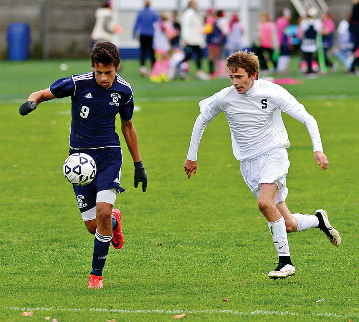 Hour photo / Erik Trautmann Staples High School # takes on Wilton in boys soccer Saturday in Westport.
