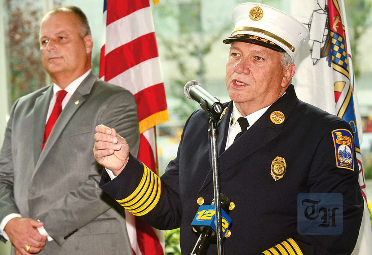 Hour photo / Erik Trautmann Chief of the Stamford Fire Department, Peter Brown, announces his retirement while Director of Public Safety, Ted Jankowski, looks on, during a press conference at the Stamford Government Center Wednesday.