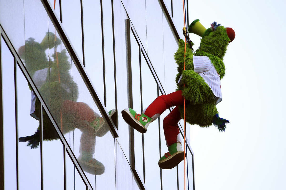 The Philadelphia Phillies' mascot, the Phillie Phanatic, rappels down a skyscraper as part of a annual fundraiser Friday, Oct. 23, 2015, in Philadelphia. The event was a fundraiser for the Outward Bound School, which offers outdoor programs aimed at building character and leadership skills. (AP Photo/Matt Rourke)