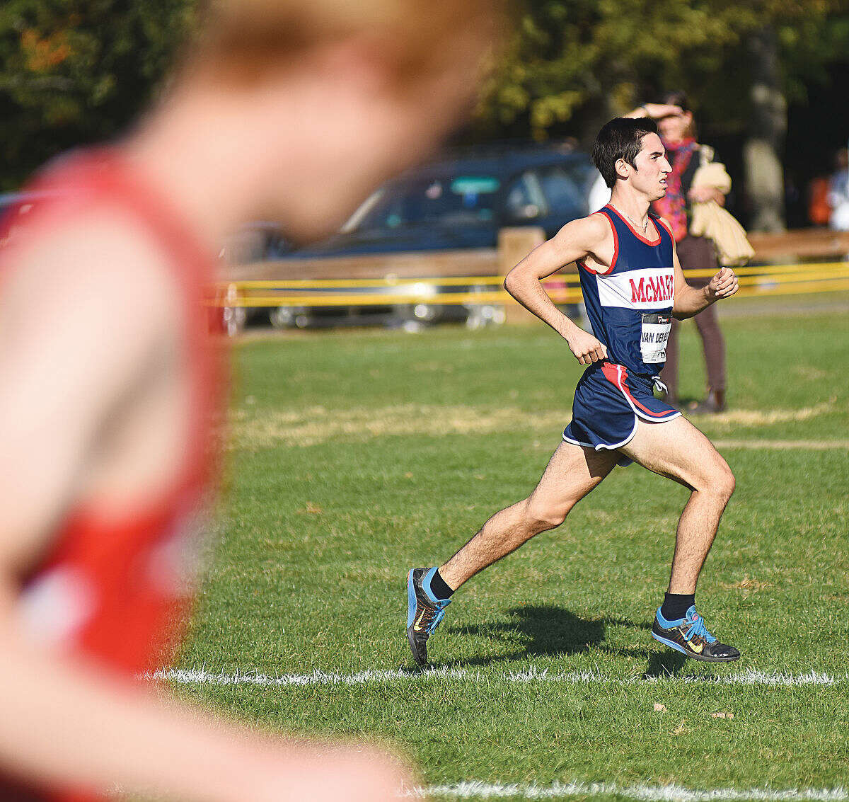 Hour photo/John Nash - Brien McMahon's Eric van der Els pulls away to an early lead right at the start of Wednesdsay's FCIAC boys cross country varsity championship race en route to becoming the first Senators runner to ever win the league title at Waveny Park in New Canaan.