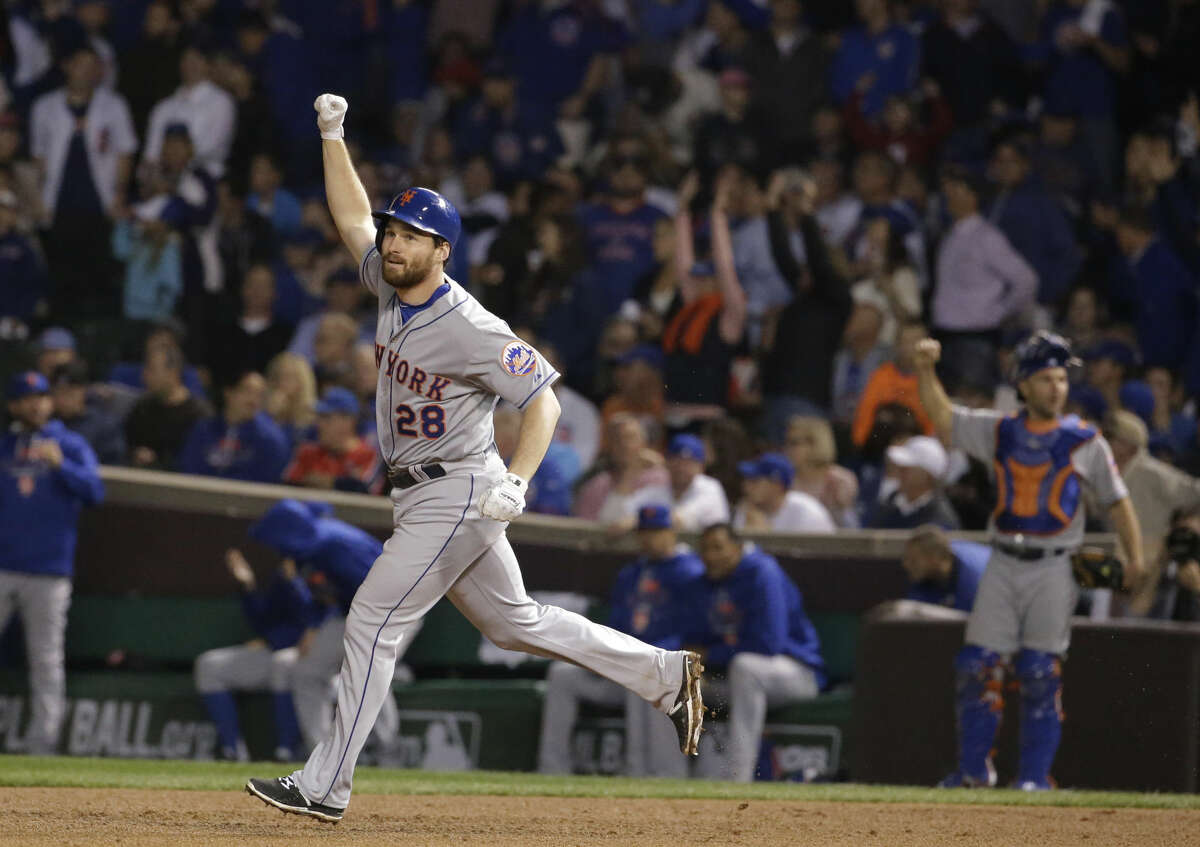 New York Mets' Daniel Murphy celebrates after hitting a two-run home run during the eighth inning of Game 4 of the National League baseball championship series against the Chicago Cubs Wednesday, Oct. 21, 2015, in Chicago. (AP Photo/Nam Y. Huh)
