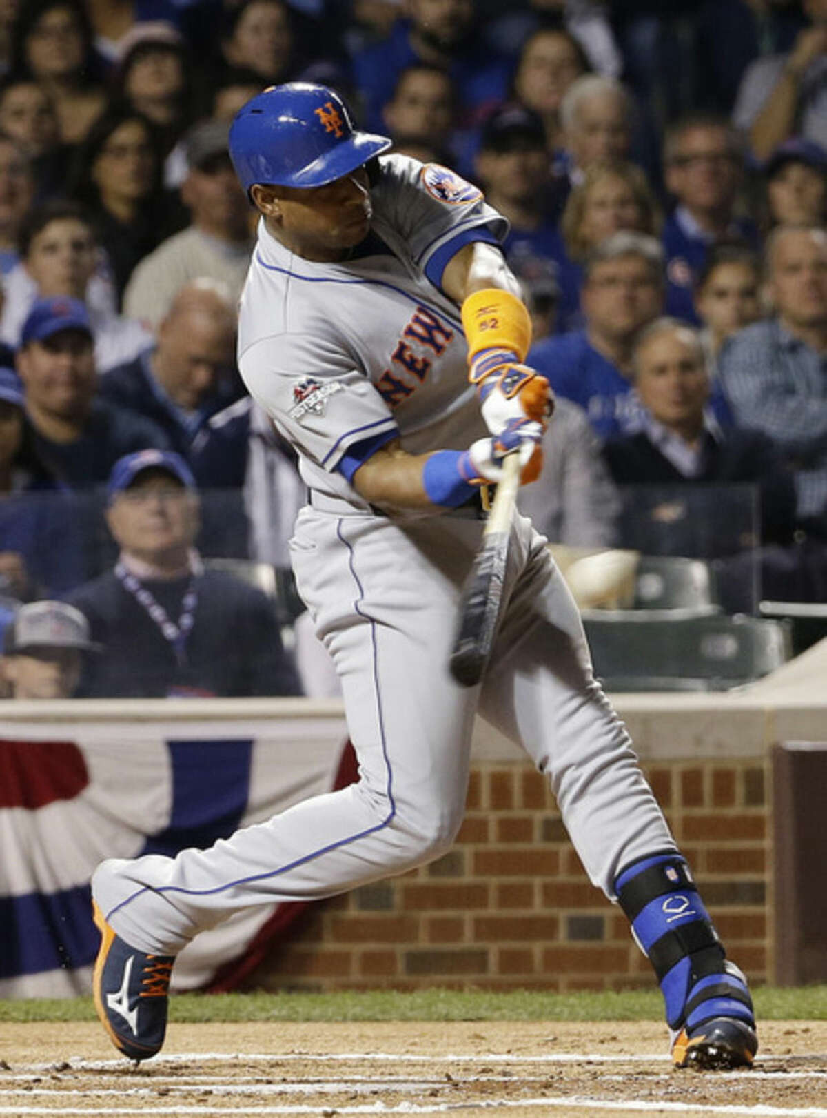 New York Mets' Yoenis Cespedes hits an RBI double during the first inning of Game 3 of the National League baseball championship series against the Chicago Cubs Tuesday, Oct. 20, 2015, in Chicago. (AP Photo/David J. Phillip)