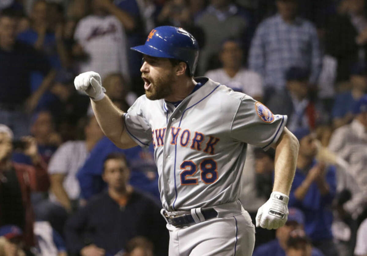 New York Mets' Daniel Murphy celebrates after hitting a two-run home run during the eighth inning of Game 4 of the National League baseball championship series against the Chicago Cubs Wednesday, Oct. 21, 2015, in Chicago. (AP Photo/David J. Phillip)