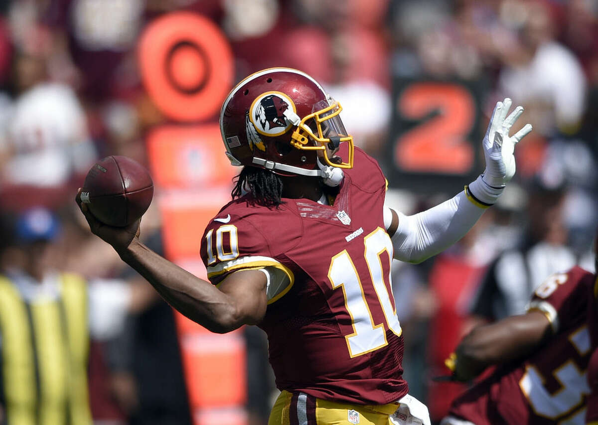 Washington Redskins quarterback Robert Griffin III (10) passes the ball  during the first half of an